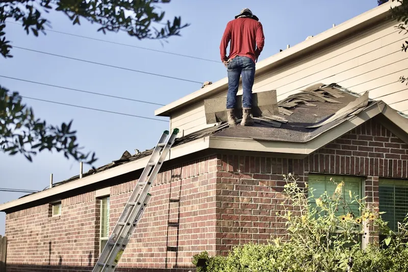 Professional roofer working on a residential roof in Rolling Hills